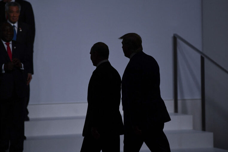 TOPSHOT - US President Donald Trump (R) walks with Russia's President Vladimir Putin before taking a family photo at the G20 Summit in Osaka on June 28, 2019. (Photo by Brendan Smialowski / AFP) (Photo by BRENDAN SMIALOWSKI/AFP via Getty Images)