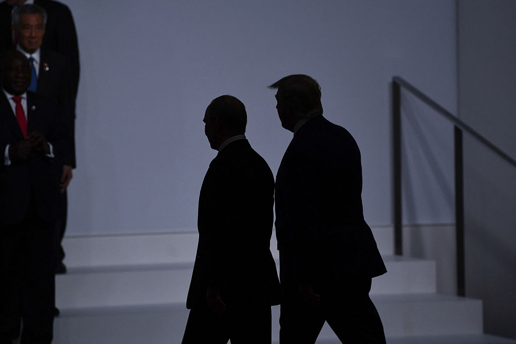 TOPSHOT - US President Donald Trump (R) walks with Russia's President Vladimir Putin before taking a family photo at the G20 Summit in Osaka on June 28, 2019. (Photo by Brendan Smialowski / AFP) (Photo by BRENDAN SMIALOWSKI/AFP via Getty Images)