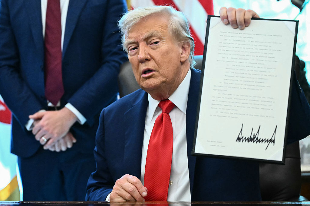 US President Donald Trump holds up an executive order he signed that aims to end cashless bail, in the Oval Office of the White House in Washington, DC on August 25, 2025. Also pictured, L/R, US Attorney General Pam Bondi, Vice President JD Vance, Defense Secretary Pete Hegseth and US Secretary of Homeland Security Kristi Noem (Photo by Mandel NGAN / AFP) (Photo by MANDEL NGAN/AFP via Getty Images)