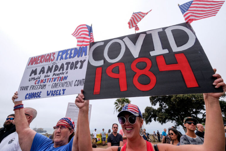 Anti-vaccination protesters holding signs take part in a rally against Covid-19 vaccine mandates, in Santa Monica, California, on August 29, 2021. (Photo by RINGO CHIU / AFP) (Photo by RINGO CHIU/AFP via Getty Images)
