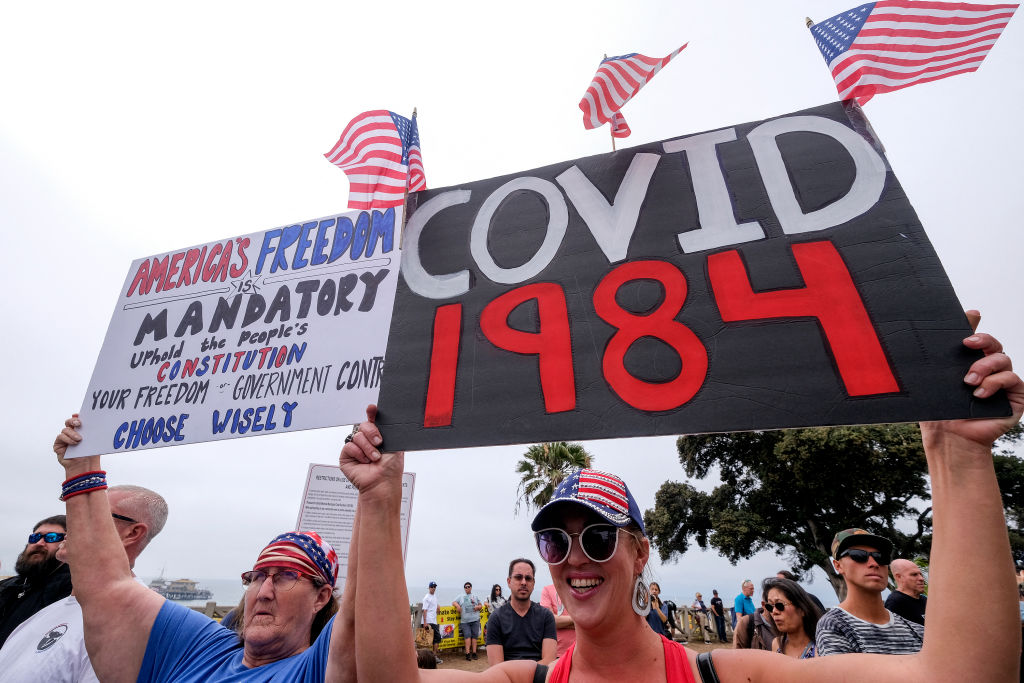 Anti-vaccination protesters holding signs take part in a rally against Covid-19 vaccine mandates, in Santa Monica, California, on August 29, 2021. (Photo by RINGO CHIU / AFP) (Photo by RINGO CHIU/AFP via Getty Images)