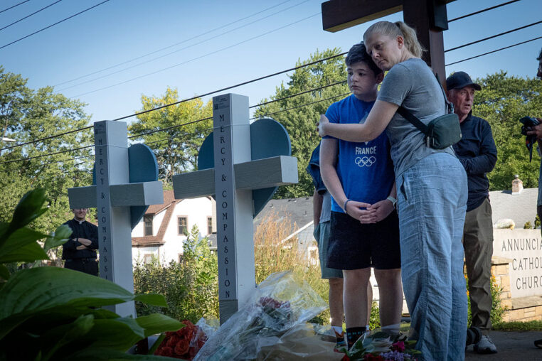 MINNEAPOLIS, MINNESOTA - AUGUST 28: People visit a memorial to yesterday's shooting victims in front of Annunciation Catholic Church on August 28, 2025 in Minneapolis, Minnesota. A gunman fired through the windows of the church while students were sitting in pews during a Catholic school Mass, killing two children and injuring at least 17 others. The gunman reportedly died at the scene from a self-inflicted gunshot wound, according to police. (Photo by Scott Olson/Getty Images)