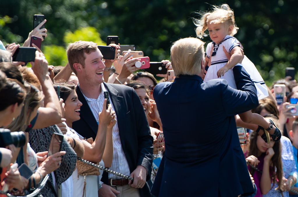 US President Donald Trump holds a baby as he greets guests prior to departing on Marine One from the South Lawn of the White House in Washington, DC, July 5, 2019. - Trump travels to Bedminster, New Jersey. (Photo by SAUL LOEB / AFP) (Photo by SAUL LOEB/AFP via Getty Images)
