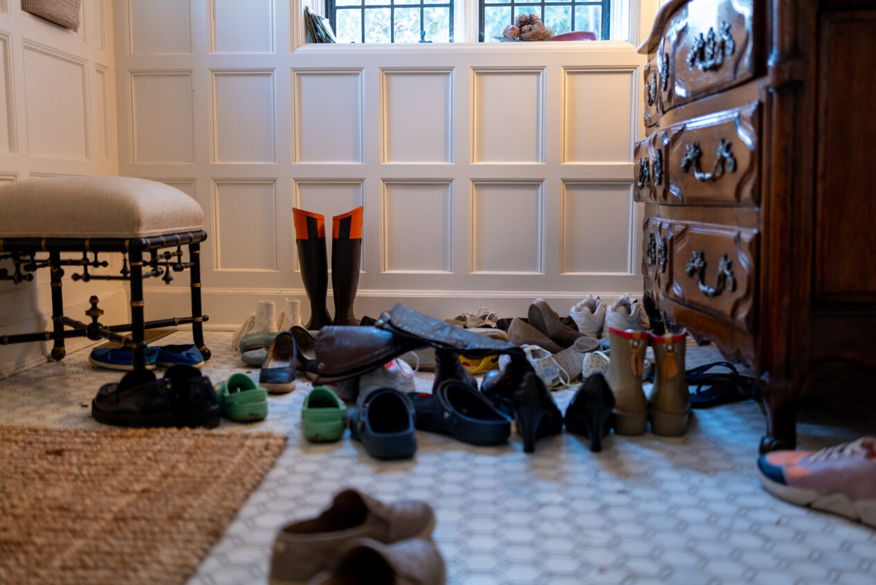 assortment of family’s shoes removed & stored in foyer