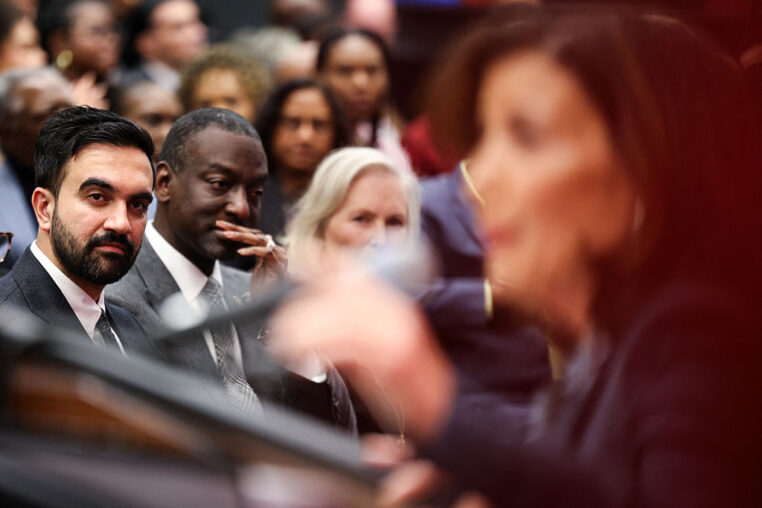 New York City Mayor-elect Zohran Mamdani (L) looks on as New York Governor Kathy Hochul speaks during the grand opening of the Urban League Empowerment Center by the National Urban League in Harlem in the Manhattan borough of New York City, on November 12, 2025. The National Urban League is opening its new headquarters to house the Civil Rights Museum and offer affordable housing, retail space, and community facilities in a 17-story building. (Photo by CHARLY TRIBALLEAU / AFP) (Photo by CHARLY TRIBALLEAU/AFP via Getty Images)